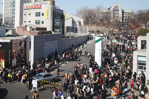 名門女子大として知られる梨花女子大学の前には、春休みにもかかわらず大勢の人でにぎわいます。