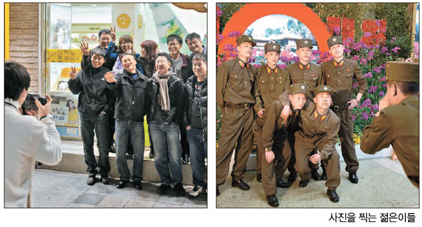 写真を撮る若者たち（左が韓国、右は北朝鮮）（写真＝写真集より）