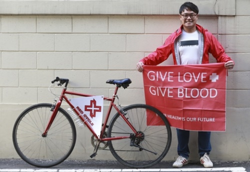 ネパール・ヒマラヤなどの地域で献血証寄付キャンペーンに使われた立て札を見せているイム・チュンマンさん。