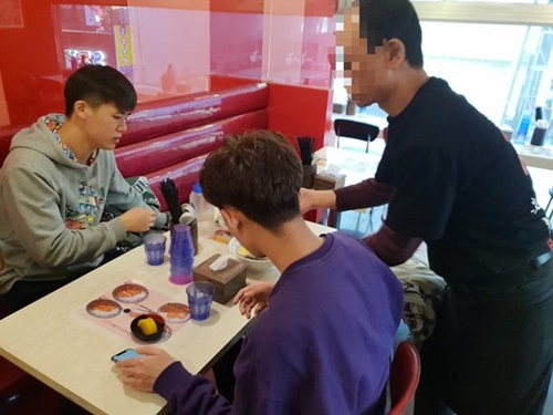 ２４日、ソウル明洞のある日本式ラーメン店で経営者のイさん（６３）が自ら接客している。客が少ない午前の時間にはイさんが注文を受けている。
