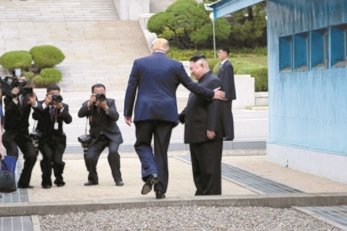 ドナルド・トランプ大統領が３０日午後、板門店で現職米国大統領としては初めて北朝鮮の地を踏んだ。金正恩委員長と挨拶を交わしたトランプ大統領が金委員長の案内で軍事境界線の境界石を超えている。北側に１０メートル程度行ってきた両首脳が自由の家の前で文在寅大統領に会い、南・北・米の板門店３者会合が実現した。（写真＝青瓦台写真記者団）