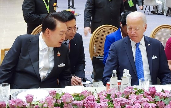 尹錫悦大統領が９日にインドのニューデリーで開かれた主要２０カ国（Ｇ２０）首脳会議の夕食会でバイデン米大統領と並んで隣の席に座り懸案について議論している。［写真　韓国大統領室］