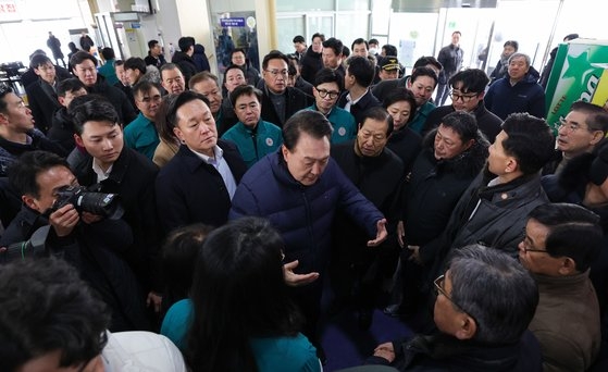尹錫悦大統領が２３日、忠清南道舒川郡舒川邑（チュンチョンナムド・ソチョングン・ソチョンウプ）の舒川特化市場の火災現場で、被害商人たちに会って会話している。［写真　大統領室］
