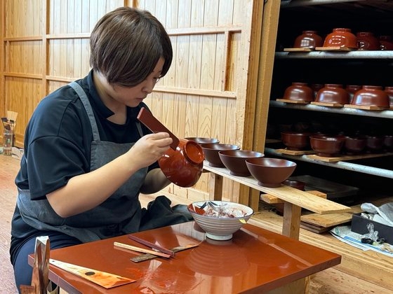 １１日、岩手県のある漆器工房で齋藤さんが木器に漆を塗っている。キム・ヒョンイェ記者