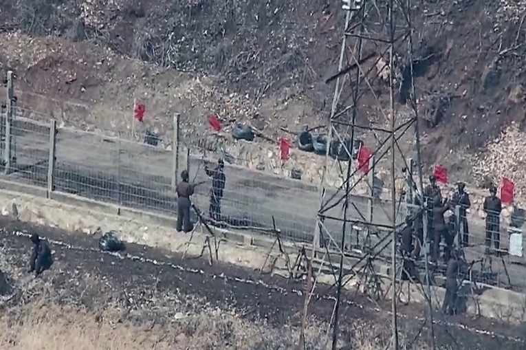韓国合同参謀本部が最近の北朝鮮軍活動資料を先月２７日、公開した。写真は北朝鮮軍が東部戦線の鉄柵上下段を補修している様子。［写真　韓国合同参謀本部］