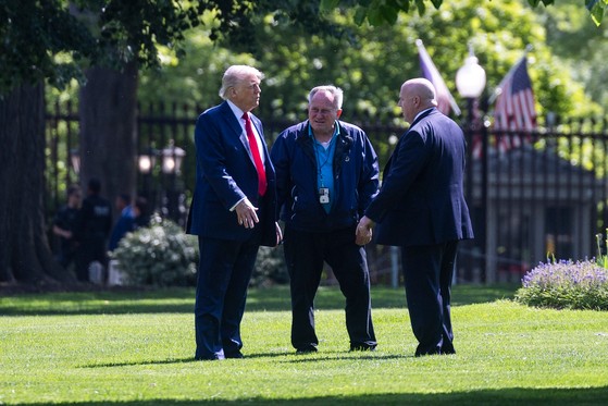 ドナルド・トランプ米大統領が２３日（現地時間）、ワシントンＤ．Ｃ．のホワイトハウス北側庭園「ノースローン」で庭園管理責任者らと大型旗竿設置に関連した言葉を交わしている。［写真　ＥＰＡ＝聯合］