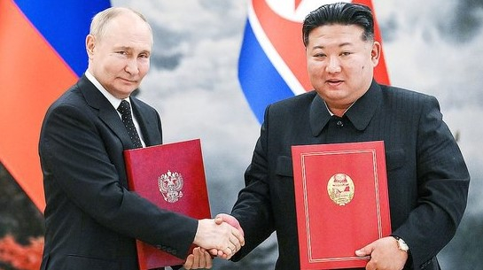 ロシアのプーチン大統領と北朝鮮の金正恩国務委員長が２０２４年６月、平壌（ピョンヤン）で首脳会談をした後、署名した条約文を見せている。双方は冷戦時代の軍事同盟を事実上復元した。　［聯合ニュース］