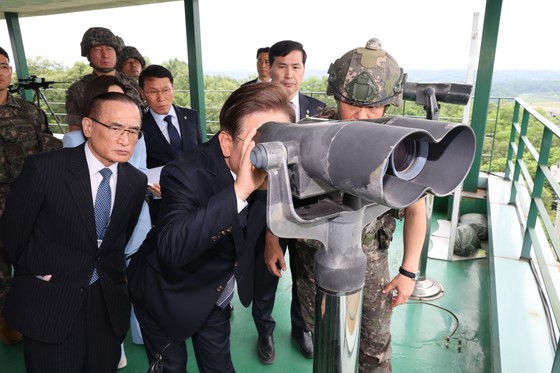 李在明（イ・ジェミョン）大統領が１３日、京畿道漣川郡（ヨンチョングン）第２５師団の展望台を訪問し、望遠鏡で北朝鮮地域を眺めている。李大統領は対北朝鮮拡声器放送の中断を直接指示した。　［大統領室写真記者団］