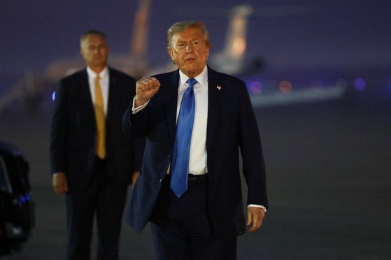 米国のドナルド・トランプ大統領が１７日（現地時間）、米国メリーランド州アンドルーズ空軍基地合同基地に到着して特有のジェスチャーを取っている。イラン核問題と関連し、Ｇ７サミット（主要７カ国首脳会議）日程中に早期帰国した。［写真　ロイター＝聯合ニュース］
