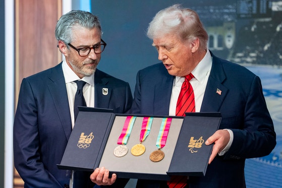トランプ米大統領が５日にワシントンで「２０２８ロス五輪タスクフォース設立」の大統領令に署名した後メダルを見ている。［写真　ＵＰＩ＝聯合ニュース］