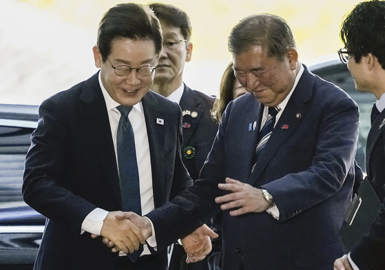  李在明大統領を出迎えている石破首相。［共同通信＝聯合ニュース］