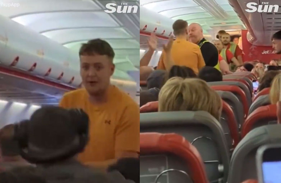   機内で騒ぎを起こした男性が警察に逮捕され、拍手する乗客たち［ザ・サン動画キャプチャー］