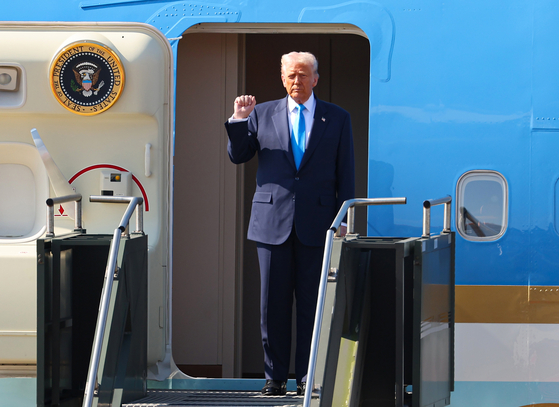 ドナルド・トランプ米大統領が29日、慶州（キョンジュ）で開かれるAPEC首脳会議を機に国賓として韓国を訪れ、釜山金海（プサン・キムヘ）国際空港に到着した。トランプ大統領は専用機「エアフォースワン」から拳を握りしめてあいさつしている。［聯合ニュース］