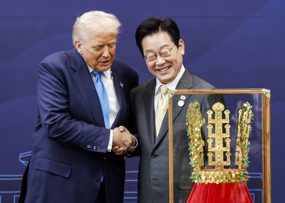 李在明（イ・ジェミョン）大統領が29日、慶州博物館でトランプ米大統領に「天馬塚金冠模型」を贈った後、握手している。 チョン・ミンギュ記者