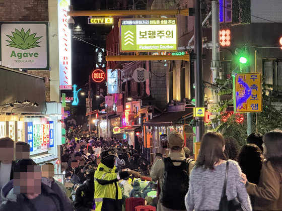 31日、ソウル竜山区梨泰院（イテウォン）世界飲食通りの混雑状況を知らせる電光掲示板に「歩行注意」と表示されている。 イム・ソンビン記者