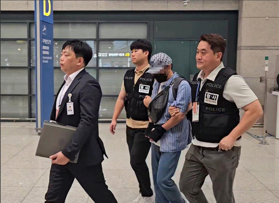 カンボジアを拠点とするノーショー詐欺組織の被疑者が、仁川（インチョン）国際空港を通じて韓国国内に移送されている様子。［写真　江原（カンウォン）警察庁］