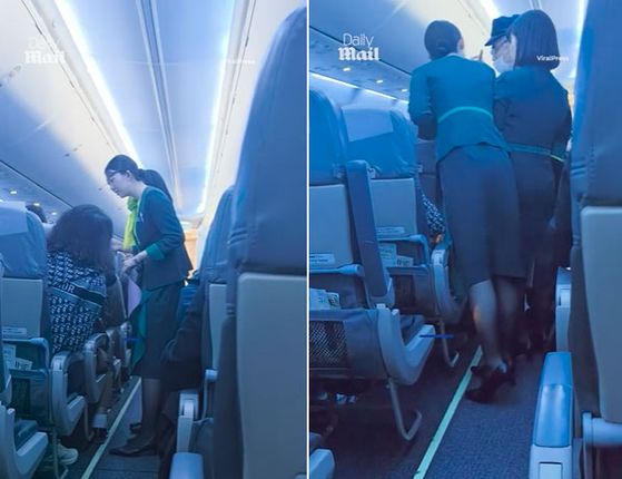  機内で騒ぎを起こした男性と乗務員の様子［デイリーメール　映像キャプチャー］