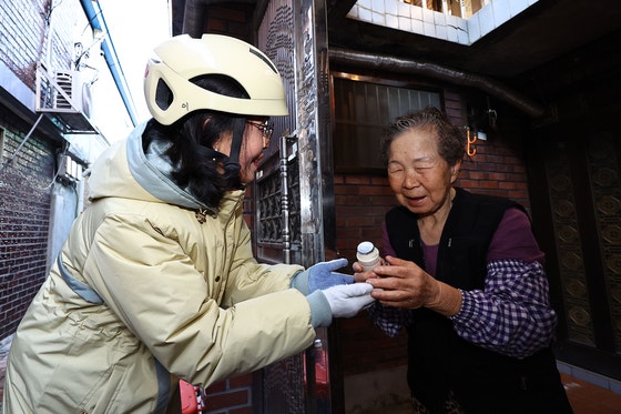 hyフレッシュマネージャーのソン・グムジュさんが18日、ソウル東大門区清凉里洞（トンデムング・チョンニャンニドン）一帯の住宅街で、一人暮らし高齢者のキム・オクスンさんにヨーグルトを届けている。キム・ジョンホ記者