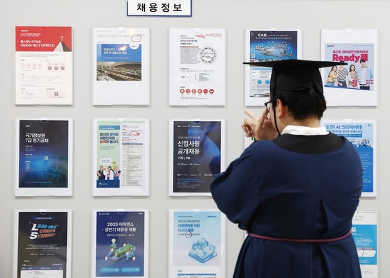  2025年夏学位授与式が開かれた8月、ソウルの成均館大学で卒業生が就職情報掲示板を見ている。［写真 ニュース1］