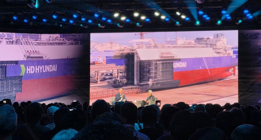 6日の米ラスベガスで開催されたCES2026でシーメンスのローランド・ブッシュCEO（左）とエヌビディアのジェンスン・フアンCEOが対談しながらHD現代を言及する中で、背後にHD現代の造船所が映し出されている。イ・ガラム記者