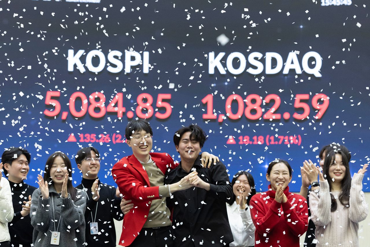 27日午後、ソウルのKRX韓国取引所で職員が終値基準KOSPI5000ポイント突破を祝っている。チョン・ミンギュ記者