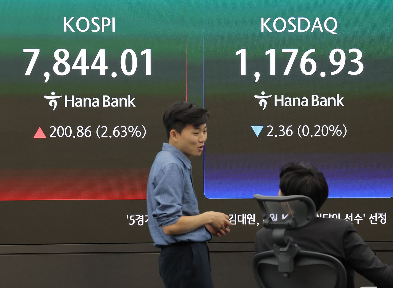 KOSPIが7844．01で過去最高値を更新した13日、ソウルのハナ銀行ディーリングルームでディーラーが業務を行っている。KOSDAQは1176．93で取引を終えた。［写真 聯合ニュース］