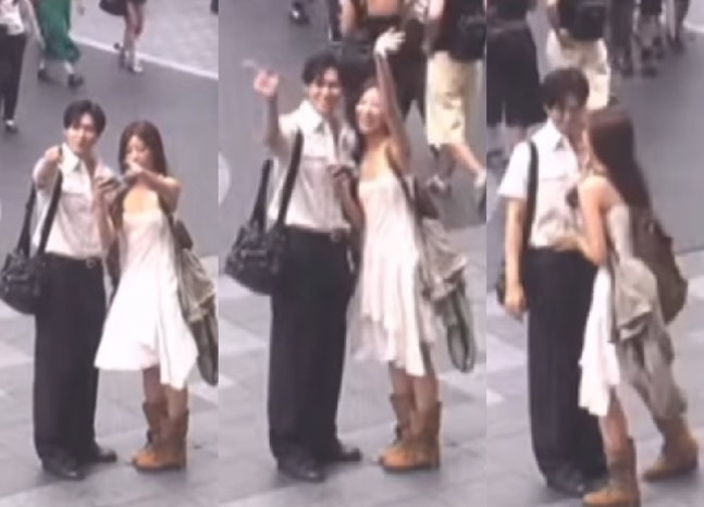   手をつなぎ、大阪の街頭カメラ映像を楽しむキ・ヒヒョンとイ・サンユン。［SNS キャプチャー］