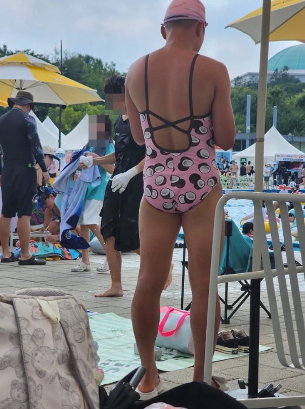   ピンクの女性ワンピース水着を着た男性 ［写真sns］